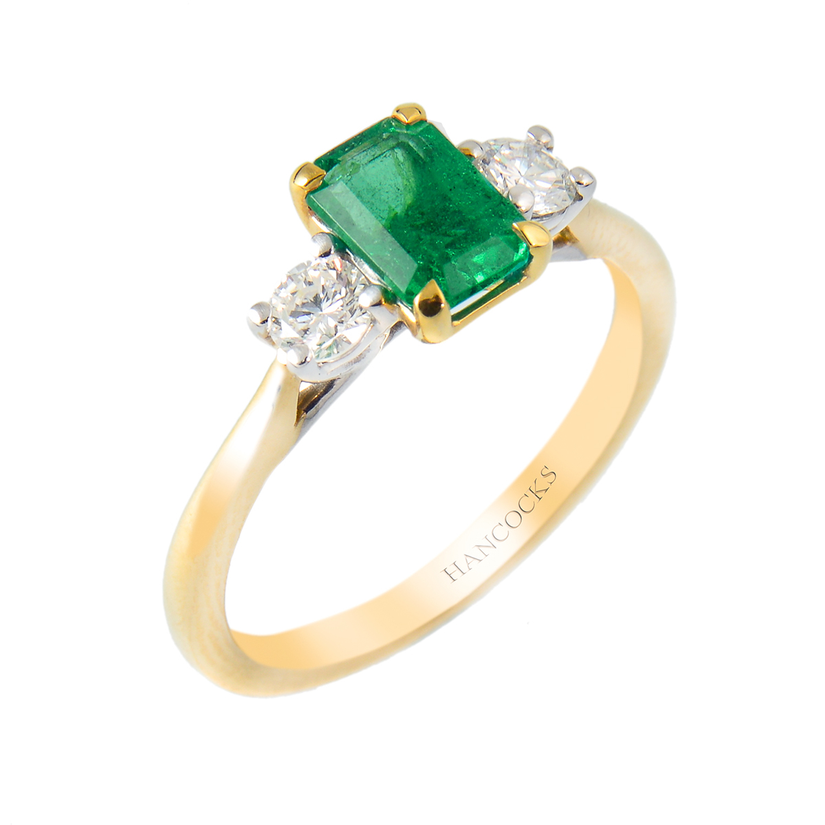 emerald and diamond three stone ring