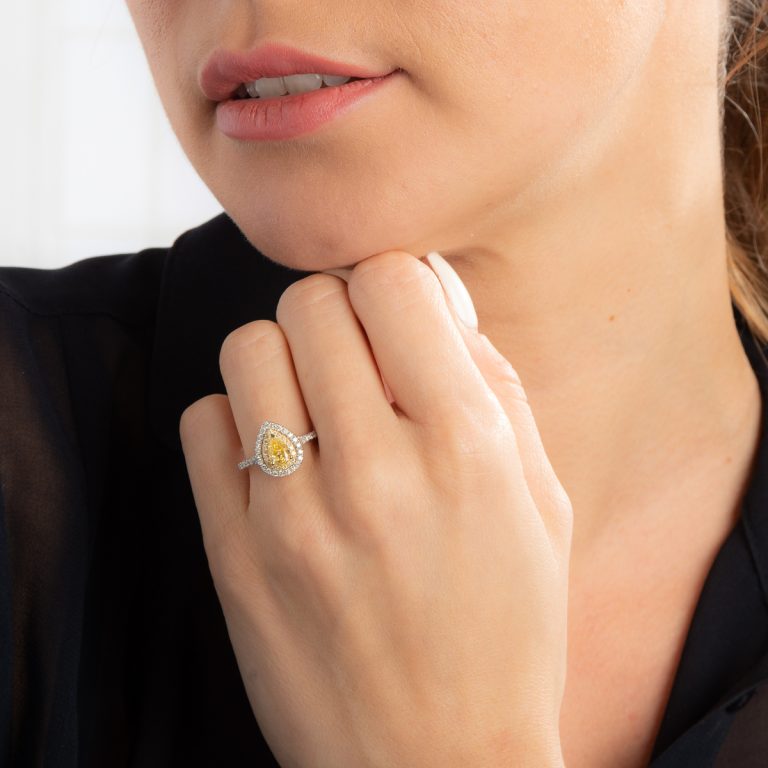 Woman wearing a yellow diamond engagement ring