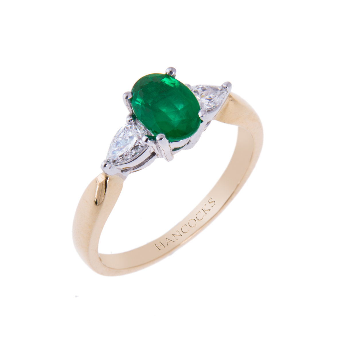 yellow gold emerald and diamond three stone ring with pear cuts