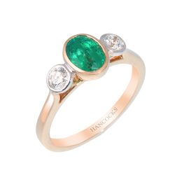 oval emerald and diamond three stone ring