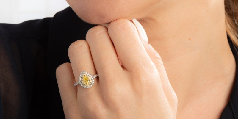 Woman wearing a yellow diamond engagement ring