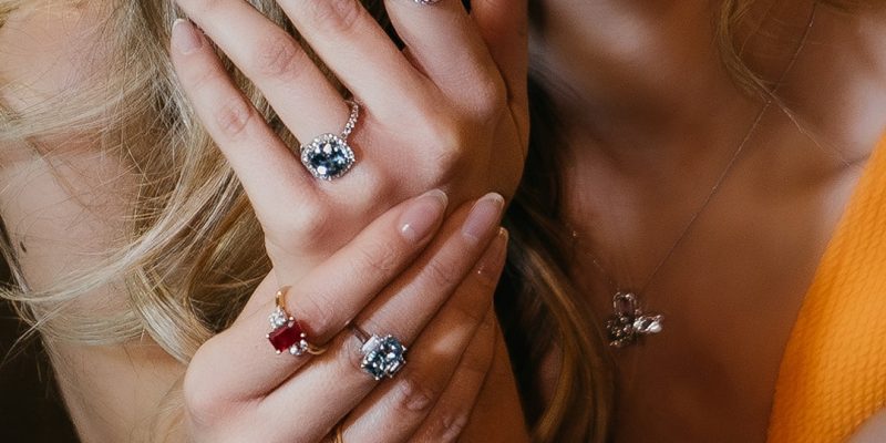 ladies hand wearing multiple engagement rings