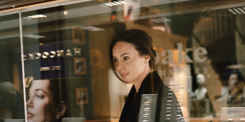 Woman looking at the jewellery at Hancocks Jewellers from the outside