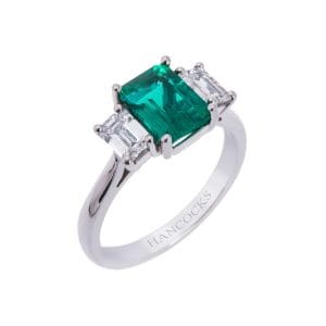 platinum claw set emerald and diamond three stone ring