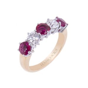 ruby and diamond half eternity in a classic claw setting